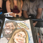 A relaxed couple having their caricature done by Ghaisar